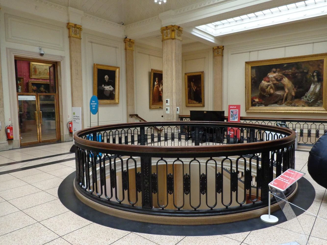 Framed historic paintings and architecture inside Walker Art Gallery, Liverpool
