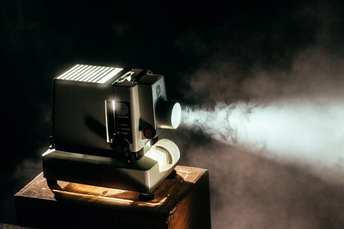 Realistic editorial photograph of an adult cinema audience applauding in a dark auditorium, anonymous faces